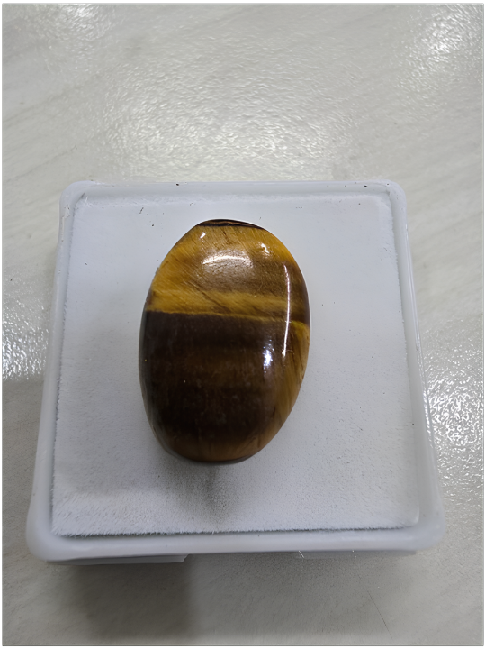 Polished tiger's-eye stone displaying chatoyancy